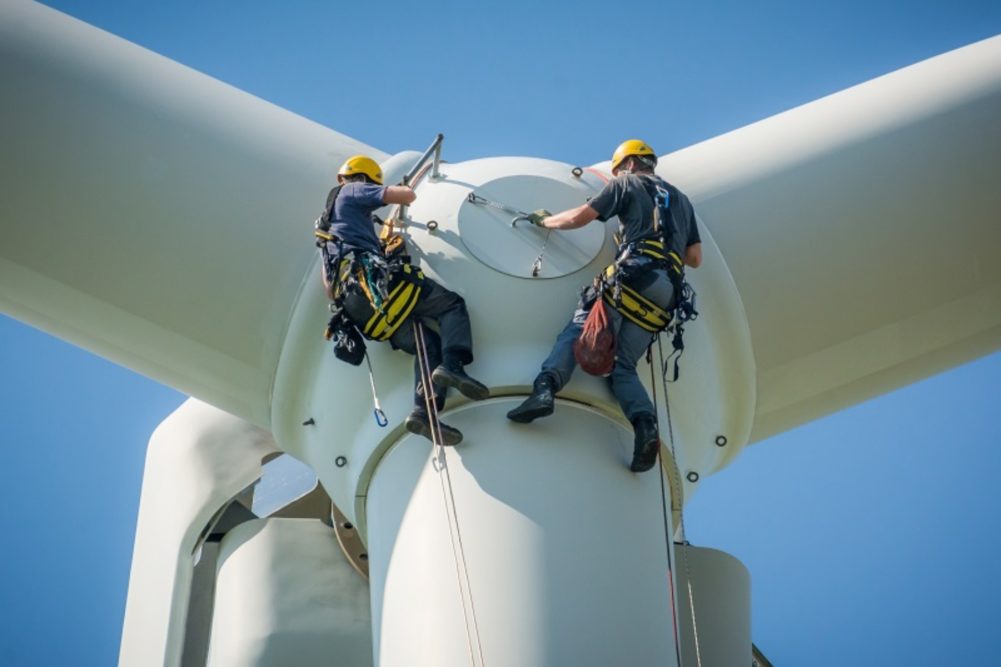 Wind turbine engineers working on renewable energy windmill
